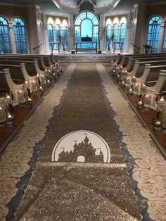 the aisle is lined with chairs and lit candles