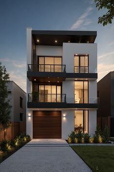 a two story house at night with lights on the balconies and an attached garage