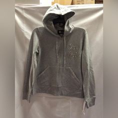 New Never Worn Or Displayed. We Have One Size Medium Left. Casual Silver Winter Outerwear, Silver Hooded Outerwear For Streetwear, Casual Silver Hooded Outerwear, Casual Silver Outerwear For Winter, Silver Hoodie For Winter, Silver Long Sleeve Hoodie For Winter, Silver Long Sleeve Hoodie For Fall, Silver Hoodie For Winter Streetwear, Silver Casual Winter Hoodie