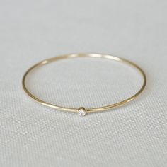 The Delicate Diamond – Yearly Company Minimalist White Gold Bangle With Single Cut Diamonds, Minimalist White Gold Diamond Bangle, Timeless Anniversary Bangle With Single Diamond, Timeless Single Diamond Bangle For Anniversary, Fine Jewelry Bangle With Single Diamond, Minimalist Diamond Round Bangle, Minimalist Single Cut Diamond Bangle, Minimalist Round Diamond Bangle, 14k Gold Bangle With Single Diamond For Fine Jewelry