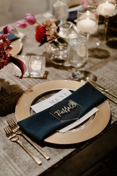 a place setting with silverware and napkins on a dining room table set for an elegant dinner