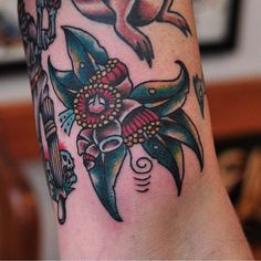 a close up of a person's leg with tattoos on it and an animal