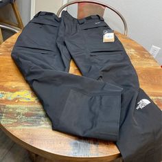 Black North Face Ski Pants. Dryvent Fabric That Is Waterproof, Wind Proof And Breathable. Adjustable Velcro Waist Four Large Front Zippered Pockets And One Back Zippered Pocket. Inner-Thigh Vents. Black Utility Pants For Outdoor, Black Pants With Functional Pockets For Outdoor Activities, Black Functional Pants For Outdoor Activities, Black Pants With Hip Pockets For Outdoor Activities, Black Hiking Pants With Pockets, Waterproof Cargo Pants For Winter Outdoor Activities, Black Utility Bottoms For Outdoor Work, Black Cargo Bottoms For Outdoor Work, Winter Waterproof Cargo Pants For Outdoor