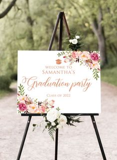 a welcome sign with flowers and greenery on it