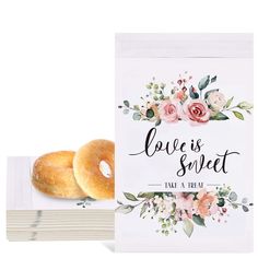 two donuts sitting on top of each other in front of a card that says love is sweet