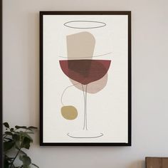 a framed art print with a glass of wine on the wall next to a potted plant