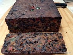 two pieces of chocolate cake sitting on top of a cutting board