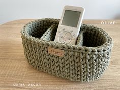 a cell phone in a knitted basket on a table