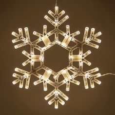 a lighted snowflake hanging from the ceiling