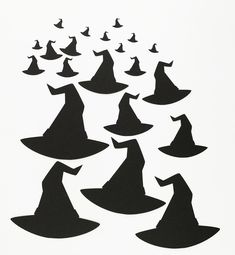 black silhouettes of witches flying through the air with their hats on top of them