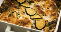 a casserole dish with zucchini and cheese