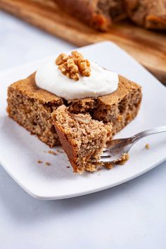 a piece of cake sitting on top of a white plate with a fork in it