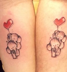 two elephants with heart balloons on their legs