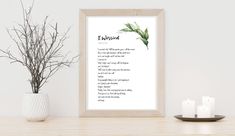 a white framed print with the words twilight on it next to some candles and a potted plant