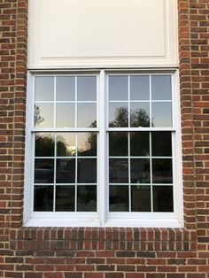 a brick building with two white windows on each side