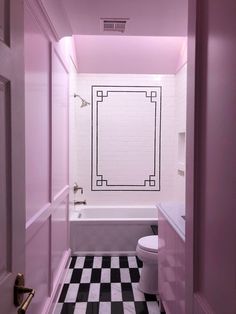 a bathroom with black and white checkered flooring next to a bathtub, toilet and sink