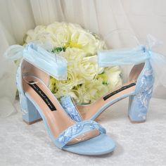 a pair of blue high heeled shoes next to a bouquet