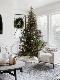 a living room with a christmas tree in the corner