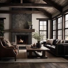 a living room with two couches and a fire place in the middle of it