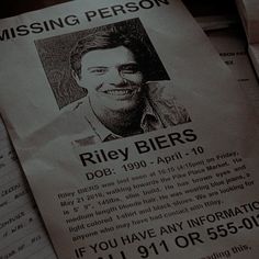 a missing person poster sitting on top of papers