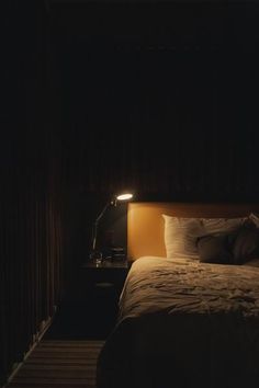 a dimly lit bed in a dark room