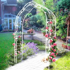 a garden with flowers and a bench in the middle