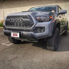 a gray toyota truck parked in a parking lot