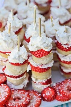 strawberries and cream covered desserts on sticks