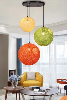 three colorful lights hanging from the ceiling in a living room