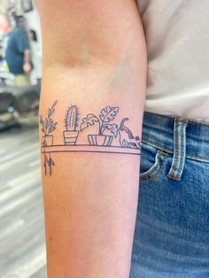 Houseplant tattoo Plant Theme Tattoo, Cat Arm Band Tattoo, Cat On Shelf Tattoo, Gardening Tattoos For Women, Arm Plant Tattoos For Women, Shelf Tattoo Design, Plant Outline Tattoo, Plant And Cat Tattoo, Line Art Plant Tattoo