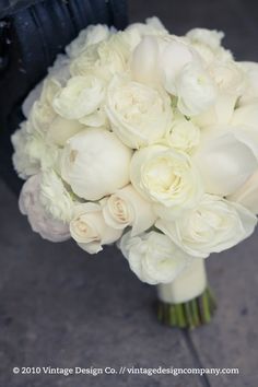 a bouquet of white flowers sitting on top of a table