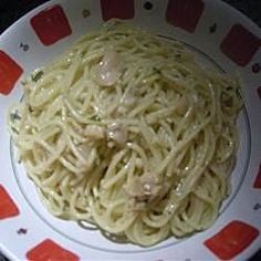 a white plate topped with pasta covered in sauce