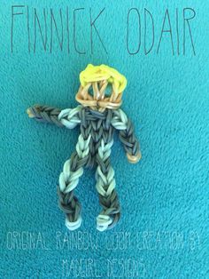 an ornament made from loom yarn is shown on a blue background with the words finnick odair written above it