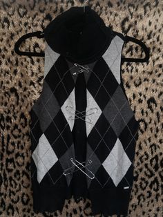 a black and white argyle sweater vest with ties