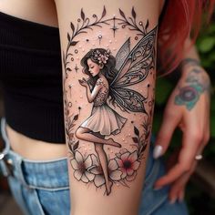 a woman's leg with a tattoo on it and a fairy holding a flower