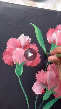 someone is painting pink flowers with green stems