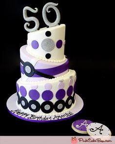 a 50th birthday cake with purple and white polka dots