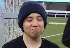 a person wearing a beanie making a face