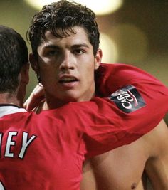 two young men embracing each other in a soccer game