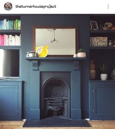 a living room with a fire place and bookshelves