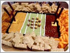 a football field platter with chips, dips and crackers on the side