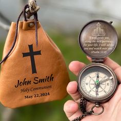 a person holding a compass and a bag with the words john smith written on it