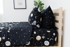 a bed with black and white space themed sheets