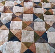 a patchwork quilt with various colors and shapes