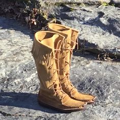 These knee high boots are made from our sand colored suede and has a steer hide canoe sole.   The upper part is constructed of a firmer more heavy suede with a canoe sole made of a our more durable steer hide.  With these being made from suede they are very soft and conform to your foot immediately.  And the double sole made of steerhide makes them more durable and lengthens the life of the boot.   This awesome knee high boot is great for bow hunters, mountain men, and re enactors.  So buy a pair for that rugged man in your life or a pair for yourself.                     IMPORTANT  When placing your order, to ensure a more precise fit, we MUST have the following two ACCURATE measurements both taken with bare feet:  First, make a tracing of your feet then measure from tip of big toe to bac Knee High Moccasins, Moccasins Boots, Mukluk Boots, Mens Western Wear, Handmade Moccasins, Barefoot Boots, Mountain Men, Native American Clothing, Indian Accessories