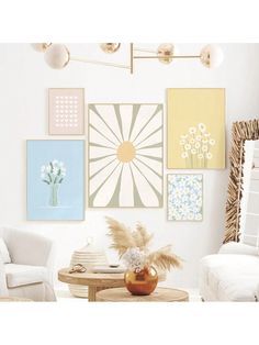 a living room filled with white furniture and pictures on the wall above it's coffee table