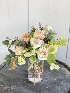 a vase filled with flowers sitting on top of a table