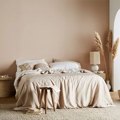 a bed sitting in a bedroom next to a wall with a clock on it's side