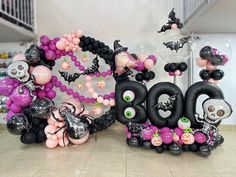 some balloons and decorations in the shape of numbers with skulls, bats and skeletons on them