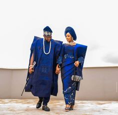 two people dressed in blue walking together